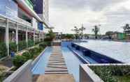 Swimming Pool 6 Modern Look 2BR Apartment Green Pramuka City near Mall By Travelio