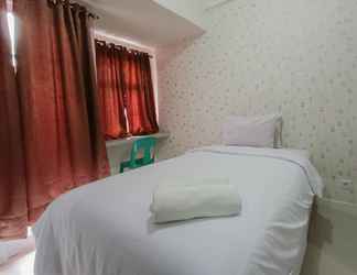 Bedroom 2 Relax and Warm Studio at Vida View Makassar Apartment By Travelio