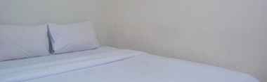 Bilik Tidur 2 Warm and Minimalist 2BR at Bassura City Apartment By Travelio