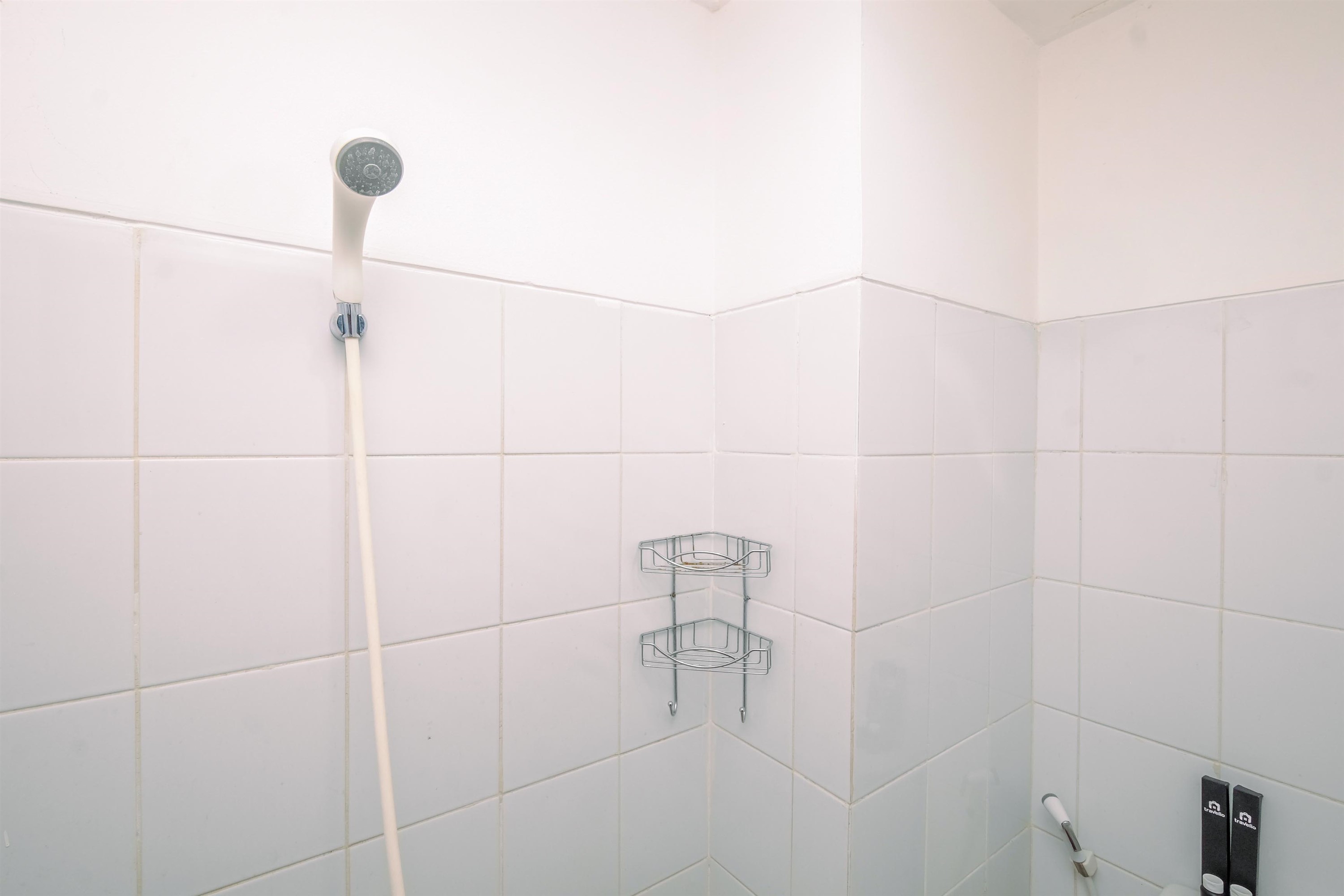 Toilet Kamar Tidy and Restful Studio at Gunung Putri Square Apartment By Travelio