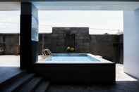 Swimming Pool Relaxing Studio at Puri Mas Apartment By Travelio