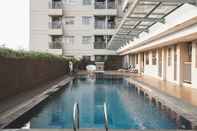 Swimming Pool Nice and Fancy Studio at Belmont Residence Puri Apartment By Travelio