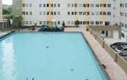 Swimming Pool 6 Homey and Comfy 2BR at Puncak Permai Apartment By Travelio