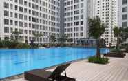 Swimming Pool 7 Homey Designed and Spacious 3BR Apartment at M-Town Residence By Travelio