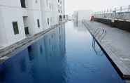 Swimming Pool 7 Minimalist and Warm 2BR at Northland Ancol Apartment By Travelio