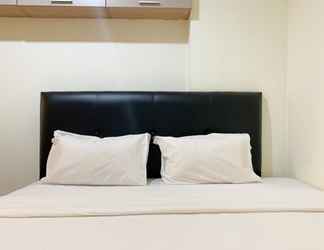 Bedroom 2 Warm and Homey 1BR Apartment at Belmont Residence Puri By Travelio