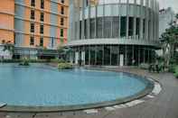 Swimming Pool Luxury 1BR at Pejaten Park Residence Apartment By Travelio