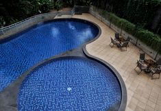 Swimming Pool 4 Warm and Cozy Studio Apartment at Dago Suites By Travelio