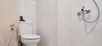 In-room Bathroom 3 Simply and Well Furnished Studio at Serpong Garden Apartment By Travelio