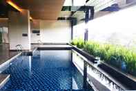 Swimming Pool Spacious and Cozy Living Studio at 28th Floor Kemang Village Apartment By Travelio