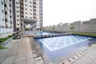 Kolam Renang Tidy and Best Choice 2BR at Puncak Dharmahusada Apartment By Travelio