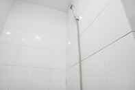 In-room Bathroom Well Designed and Cozy 2BR at Green Pramuka City Apartment By Travelio