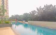 Swimming Pool 7 Full Furnished Cozy Design 2BR Apartment Transpark Cibubur By Travelio