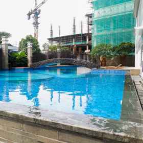 Swimming Pool 7 Spacious and Tidy 2BR at Grand Sungkono Lagoon Apartment By Travelio, Dukuh Pakis Apartments