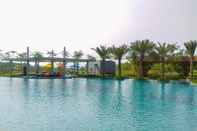 Swimming Pool Elegant and Warm 1BR Apartment at Gold Coast By Travelio