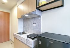 Common Space 3 Nice and Minimalist Studio Apartment at Evenciio Margonda By Travelio
