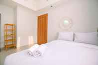 Bedroom Cozy Stay and Simple 1BR at Evenciio Margonda Apartment By Travelio