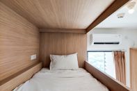 Bedroom Homey and Simple Studio Apartment at Sky House BSD By Travelio