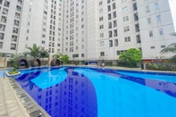 Swimming Pool Homey and Full Furnished 2BR Bassura City Apartment near Mall By Travelio
