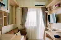 Common Space Comfort Stay 2BR Apartment at Green Pramuka City By Travelio