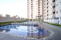 Swimming Pool Homey and Best Choice 2BR at Puncak Dharmahusada Apartment By Travelio