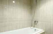 In-room Bathroom 2 Minimalist and Homey 1BR Vasanta Innopark Apartment By Travelio