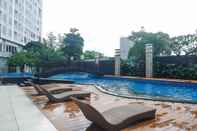 Swimming Pool Cozy and Modern 1BR at Grand Sungkono Lagoon Apartment By Travelio