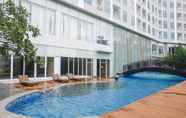 Swimming Pool 7 Cozy and Modern 1BR at Grand Sungkono Lagoon Apartment By Travelio