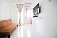 Common Space Tidy and Cozy Living 2BR at Puncak Dharmahusada Apartment By Travelio