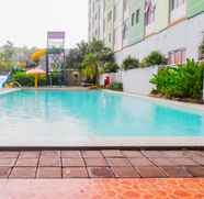 Swimming Pool 5 Homey and Simple 2BR at Dian Regency Apartment By Travelio