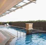 Swimming Pool 5 Warm and Homey 1BR Belmont Residence Puri Apartment By Travelio