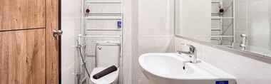 In-room Bathroom 3 Serene Studio Room Apartment at Delft Ciputra Makassar By Travelio