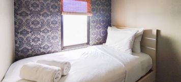 Bedroom 2 Best Stylish 2BR at Tamansari Panoramic Apartment By Travelio