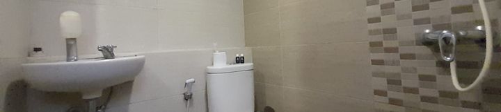 In-room Bathroom 4 Warm and Homey 1BR at Student Castle Yogyakarta Apartment By Travelio