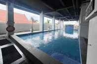 Swimming Pool Homey No Kitchen Studio at Grand Darmo Suite Apartment By Travelio