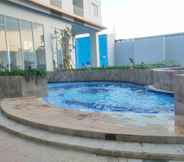 Swimming Pool 4 Cozy Living and Strategic Studio Apartment at Suncity Residence By Travelio