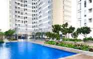 Swimming Pool 7 Restful and Modern Look 2BR Vasanta Innopark Apartment By Travelio