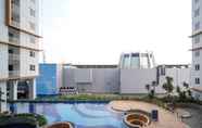 Swimming Pool 5 Homey and New 2BR Apartment at Suncity Residence By Travelio