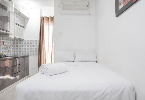 Bedroom Cozy and Tidy Studio Apartment at Bassura City By Travelio