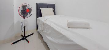 Bedroom 2 Comfortable and Warm 2BR Apartment at Bassura City By Travelio