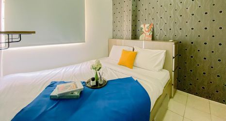 Bedroom 2 Homey and Comfortable 2BR Green Pramuka City Apartment By Travelio