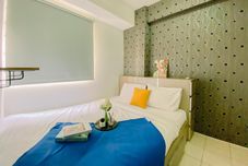 Bedroom Homey and Comfortable 2BR Green Pramuka City Apartment By Travelio