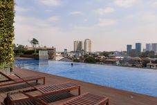 Swimming Pool Comfort Living and Nice Studio Apartment at Springwood Residence Tangerang By Travelio