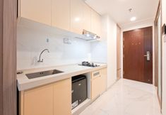 Common Space 4 Minimalist Modern Earth Tone Studio at Sky House BSD Apartment By Travelio