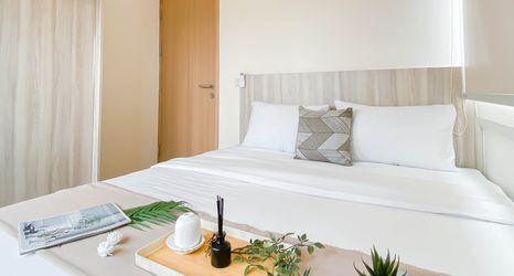 Bedroom 2 Spacious 3BR Apartment with Neutral Toned at Meikarta By Travelio