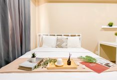 Bedroom 3 Soft Minimalist Studio Room at Apartment Meikarta By Travelio