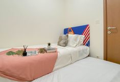 Bedroom 2 Basic 2BR Podomoro Golf View Apartment By Travelio