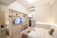 Bedroom Wooden Accent Studio at Tokyo Riverside PIK 2 Apartment By Travelio