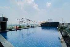 Swimming Pool Wooden Nest 2BR Without Living Room at Apartment Evenciio Margonda By Travelio