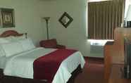 Bedroom 4 All American Inn and Suites